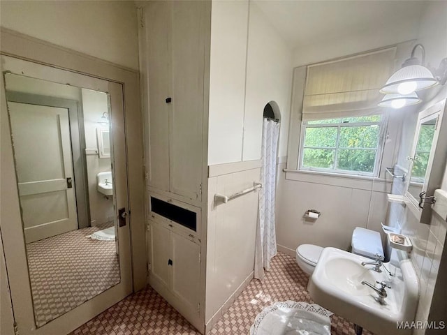 3319 Lexington Rd, Montgomery, AL 36106 - full bath featuring a shower with shower curtain and a wainscoted wall