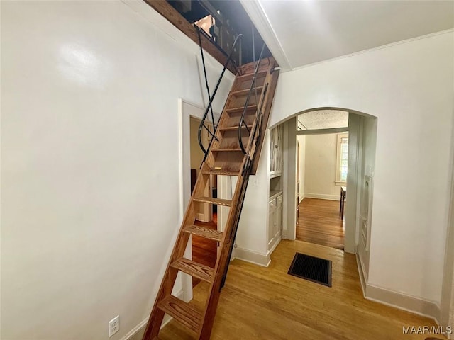 3319 Lexington Rd, Montgomery, AL 36106 - staircase with arched walkways and wood finished floors