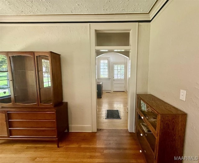 3319 Lexington Rd, Montgomery, AL 36106 - corridor featuring wood finished floors, arched walkways, and a textured wall