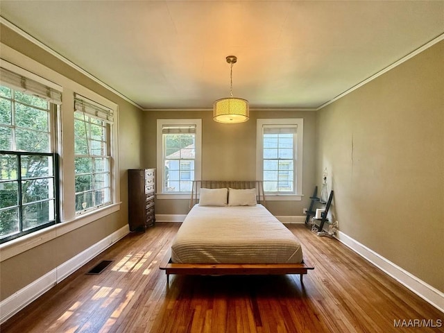 3319 Lexington Rd, Montgomery, AL 36106 - bedroom with multiple windows, wood finished floors, and ornamental molding