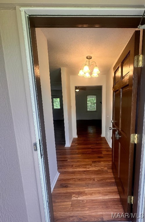 508 Columbus Dr, Selma, AL 36701 - corridor featuring a chandelier, dark wood finished floors, and healthy amount of natural light