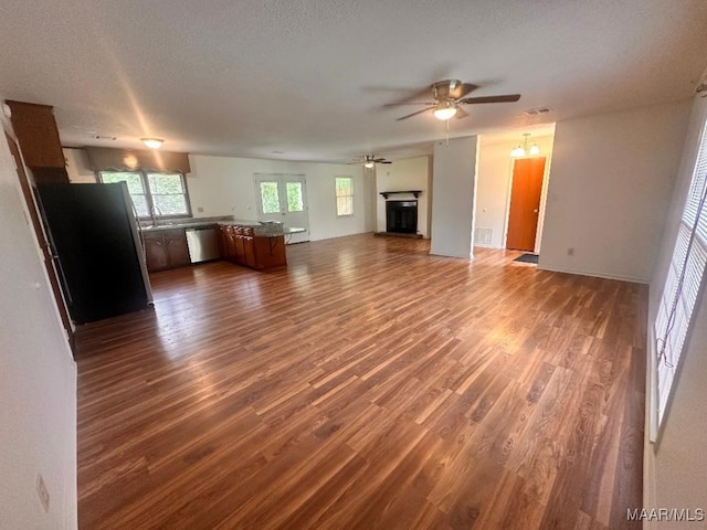 508 Columbus Dr, Selma, AL 36701 - unfurnished living room featuring ceiling fan, dark wood-type flooring, and a textured ceiling