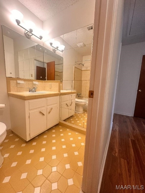 508 Columbus Dr, Selma, AL 36701 - full bathroom with a textured ceiling, vanity, and decorative backsplash