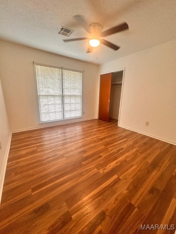 508 Columbus Dr, Selma, AL 36701 - unfurnished bedroom with a textured ceiling, wood finished floors, a ceiling fan, and a closet