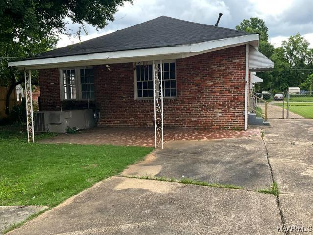 158 S Madison Ter, Montgomery, AL 36107 - rear view of property with a yard, brick siding, and a patio area