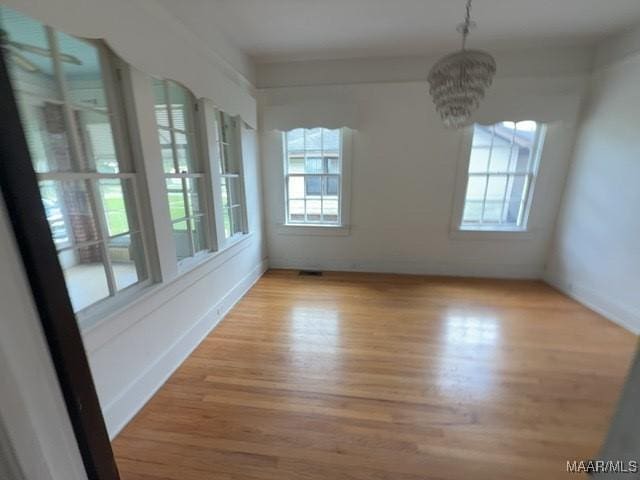 158 S Madison Ter, Montgomery, AL 36107 - unfurnished dining area featuring healthy amount of natural light, wood finished floors, and a chandelier