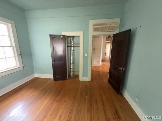 158 S Madison Ter, Montgomery, AL 36107 - unfurnished bedroom with wood finished floors and baseboards