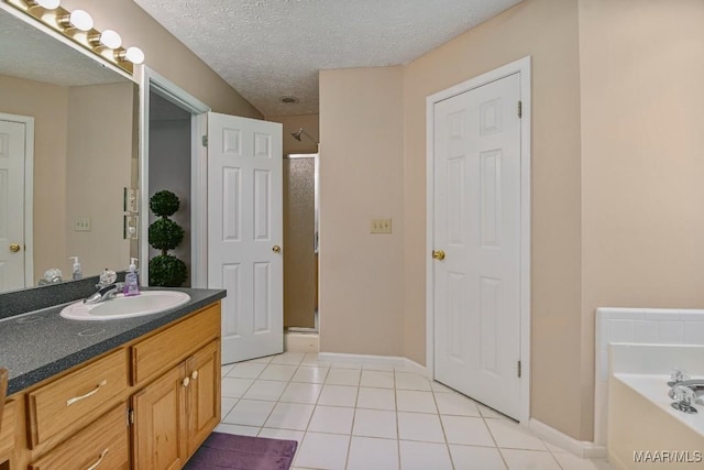 165 Ten Cedars Dr, Titus, AL 36080 - full bath with a shower stall, vanity, a bath, tile patterned flooring, and a textured ceiling