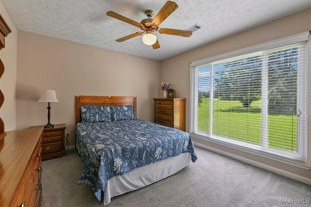 165 Ten Cedars Dr, Titus, AL 36080 - carpeted bedroom with a textured ceiling and a ceiling fan