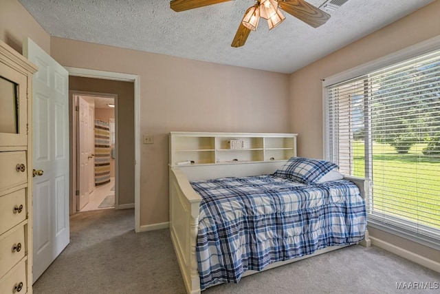 165 Ten Cedars Dr, Titus, AL 36080 - bedroom with light carpet, multiple windows, a textured ceiling, and a ceiling fan