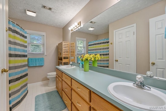 165 Ten Cedars Dr, Titus, AL 36080 - bathroom with healthy amount of natural light, double vanity, a textured ceiling, tile patterned floors, and a shower with curtain