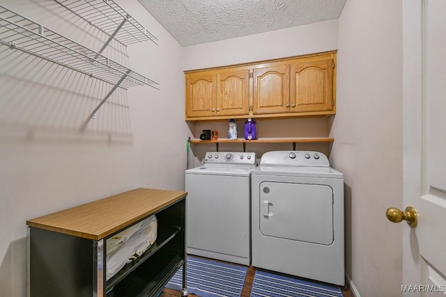 165 Ten Cedars Dr, Titus, AL 36080 - laundry room featuring washing machine and clothes dryer, cabinet space, and a textured ceiling