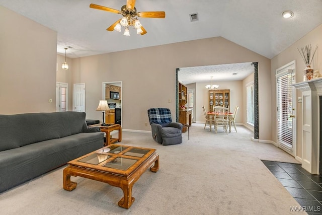 165 Ten Cedars Dr, Titus, AL 36080 - tiled living room with carpet flooring, lofted ceiling, ceiling fan, and a chandelier