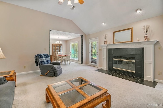 165 Ten Cedars Dr, Titus, AL 36080 - carpeted living room with vaulted ceiling, a tile fireplace, and ceiling fan