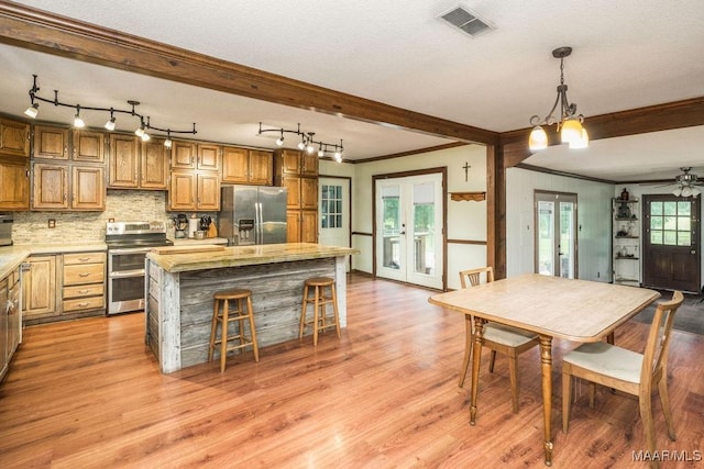 1352 Gibson Rd, Greenville, AL 36037 - kitchen featuring stainless steel appliances, french doors, crown molding, a center island, and light countertops