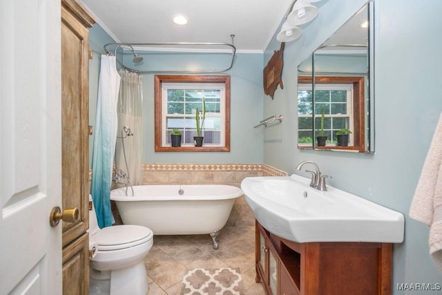 1352 Gibson Rd, Greenville, AL 36037 - full bathroom featuring a soaking tub, vanity, plenty of natural light, tile patterned flooring, and wainscoting