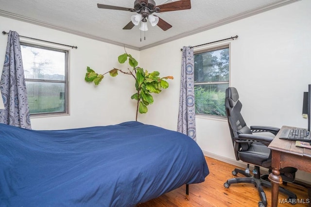 1352 Gibson Rd, Greenville, AL 36037 - bedroom with wood finished floors, ornamental molding, a desk, a ceiling fan, and a textured ceiling