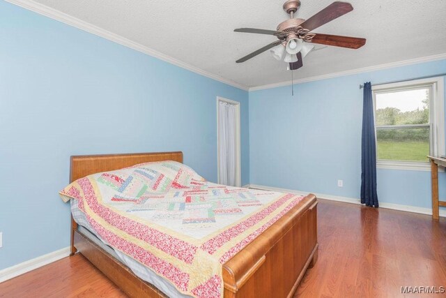 1352 Gibson Rd, Greenville, AL 36037 - bedroom featuring wood finished floors, crown molding, a textured ceiling, and a ceiling fan