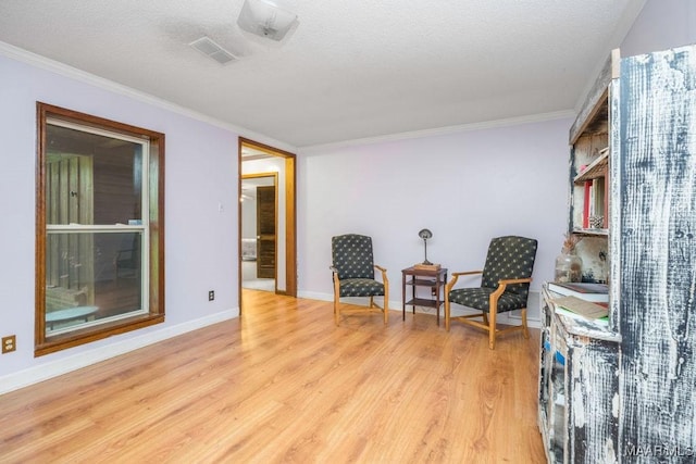 1352 Gibson Rd, Greenville, AL 36037 - sitting room featuring light wood-style flooring, ornamental molding, and a textured ceiling