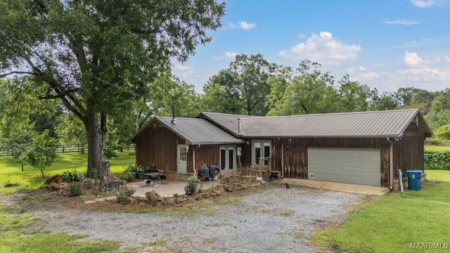 1352 Gibson Rd, Greenville, AL 36037 - view of front of property with driveway, a garage, french doors, and a metal roof
