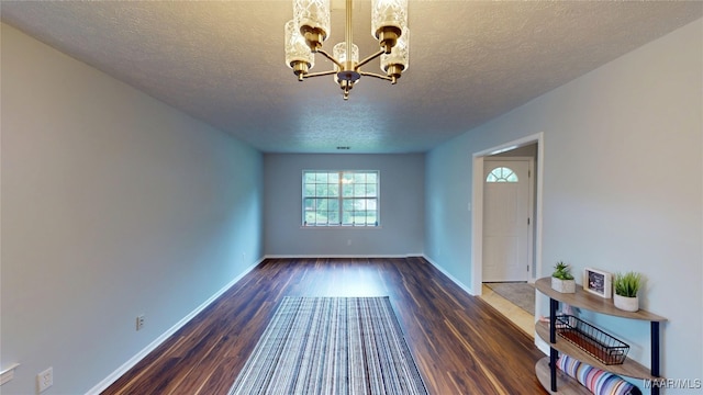 461 Glade Park Dr, Montgomery, AL 36109 - foyer entrance featuring a chandelier, a textured ceiling, and dark wood finished floors