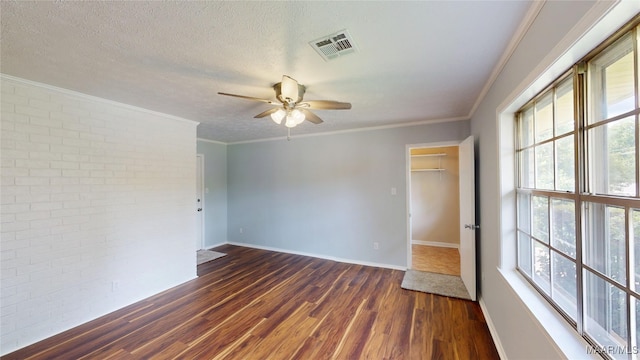 461 Glade Park Dr, Montgomery, AL 36109 - spare room featuring brick wall, dark wood finished floors, a ceiling fan, healthy amount of natural light, and crown molding