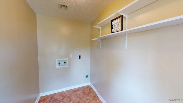461 Glade Park Dr, Montgomery, AL 36109 - laundry area featuring washer hookup, electric dryer hookup, light tile patterned floors, and a textured ceiling