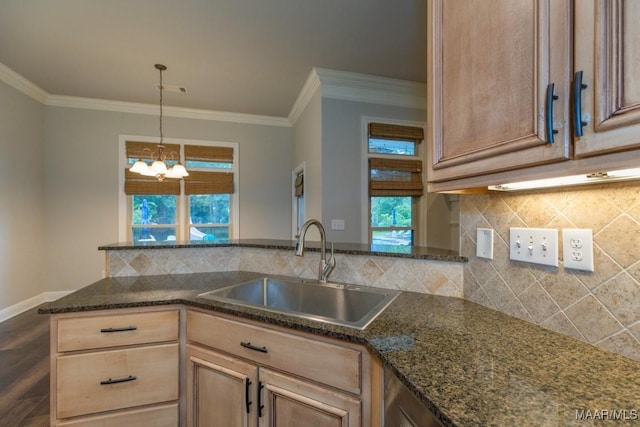 7025 Wynlakes Blvd, Montgomery, AL 36117 - kitchen with crown molding, a chandelier, dark stone countertops, healthy amount of natural light, and backsplash