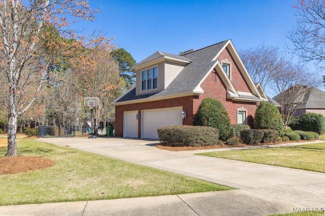 7025 Wynlakes Blvd, Montgomery, AL 36117 - view of home's exterior with an attached garage, brick siding, driveway, a lawn, and a shingled roof
