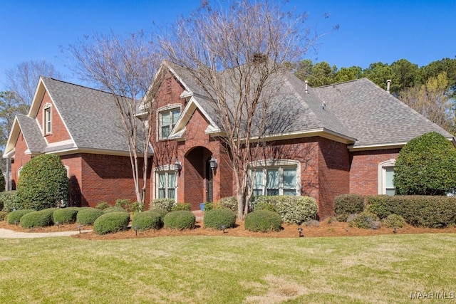 7025 Wynlakes Blvd, Montgomery, AL 36117 - view of front of home featuring brick siding, roof with shingles, and a front yard