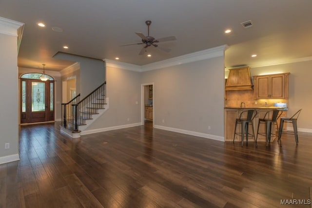 7025 Wynlakes Blvd, Montgomery, AL 36117 - unfurnished living room featuring ceiling fan, dark wood-style flooring, recessed lighting, crown molding, and stairs