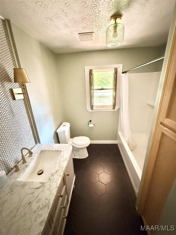 201 Greencrest Ln, Prattville, AL 36067 - bathroom with vanity, shower / bath combination with curtain, a textured ceiling, and tile patterned flooring