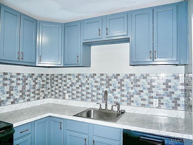 3609 Loxley Ln, Montgomery, AL 36109 - kitchen with dishwasher, decorative backsplash, blue cabinetry, stove, and light stone counters