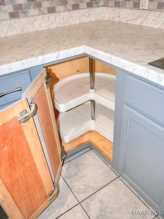 3609 Loxley Ln, Montgomery, AL 36109 - kitchen view of decorative backsplash, blue cabinets, and light stone counters
