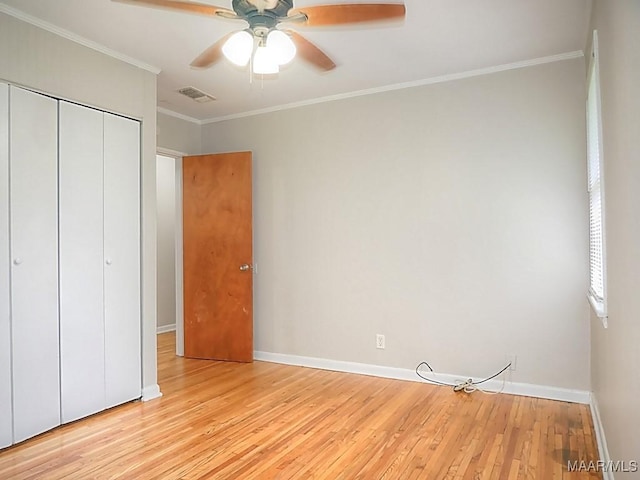 3609 Loxley Ln, Montgomery, AL 36109 - unfurnished bedroom with light wood-style flooring, a closet, crown molding, and a ceiling fan