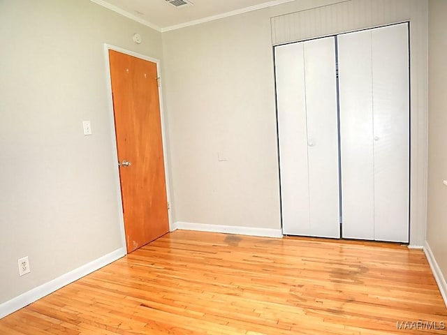 3609 Loxley Ln, Montgomery, AL 36109 - unfurnished bedroom with crown molding, light wood-style flooring, and a closet