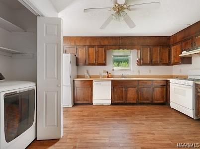 1219 First Ave, Tuskegee, AL 36088 - kitchen featuring white appliances, washer / dryer, light wood finished floors, and light countertops