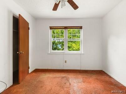 1219 First Ave, Tuskegee, AL 36088 - unfurnished bedroom featuring light carpet and ceiling fan