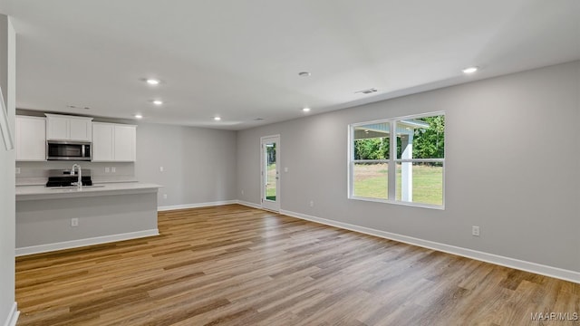 6013 Cunningham Trl, Montgomery, AL 36116 - unfurnished living room featuring light wood-style flooring and recessed lighting