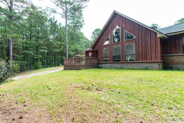 1245 Providence Rd, Titus, AL 36080 - view of side of property with a lawn, a wooden deck, brick siding, and board and batten siding