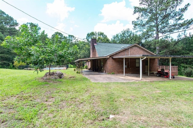 1245 Providence Rd, Titus, AL 36080 - rear view of house with a carport, a chimney, and brick siding