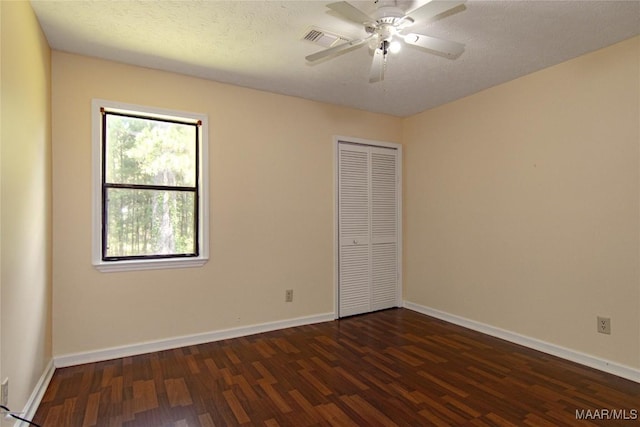 1245 Providence Rd, Titus, AL 36080 - unfurnished bedroom with dark wood-type flooring, a closet, and a ceiling fan