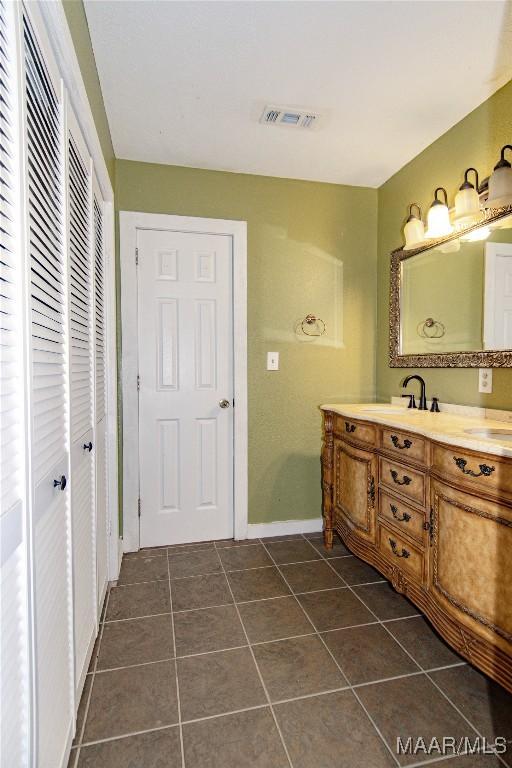 1245 Providence Rd, Titus, AL 36080 - bathroom featuring double vanity, tile patterned floors, and a closet