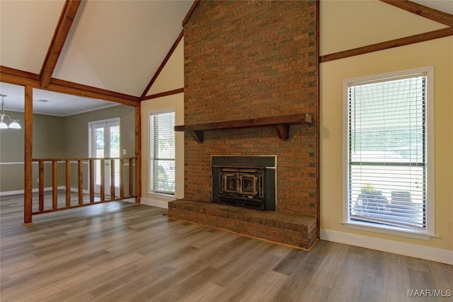 1245 Providence Rd, Titus, AL 36080 - unfurnished living room featuring high vaulted ceiling, wood finished floors, beam ceiling, and a brick fireplace