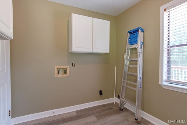 1245 Providence Rd, Titus, AL 36080 - laundry area featuring washer hookup, cabinet space, and light wood-style flooring