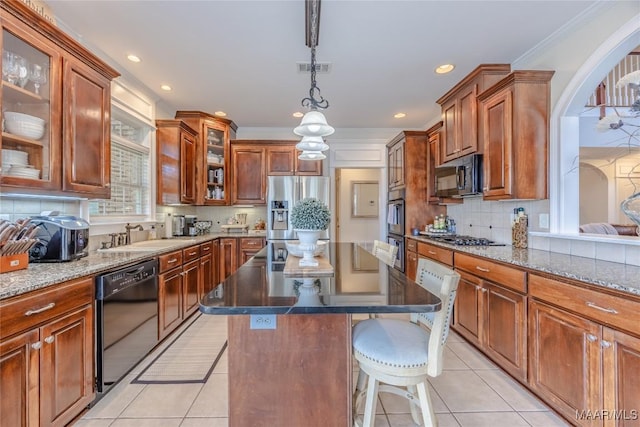 742 Mckeithen Pl, Millbrook, AL 36054 - kitchen with black appliances, light tile patterned floors, dark stone countertops, a center island, and recessed lighting