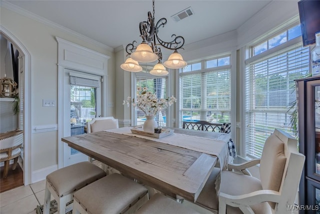 742 Mckeithen Pl, Millbrook, AL 36054 - dining space featuring a chandelier, arched walkways, light tile patterned floors, and crown molding