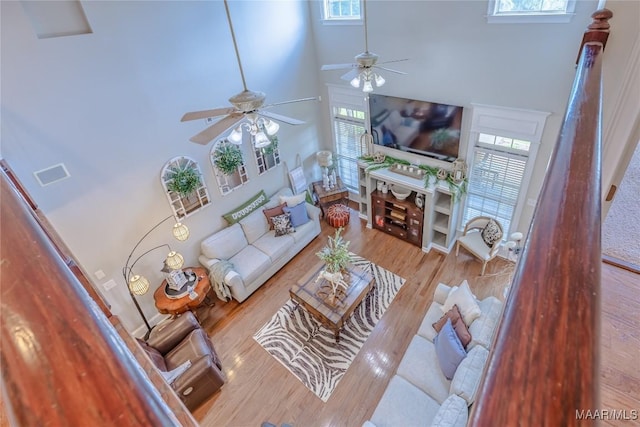 742 Mckeithen Pl, Millbrook, AL 36054 - living room featuring a towering ceiling, ceiling fan, and wood finished floors