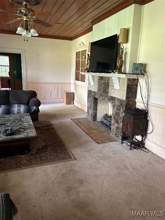 309 Broad St, Camden, AL 36726 - living room with a wainscoted wall, carpet, a ceiling fan, a fireplace, and wooden ceiling