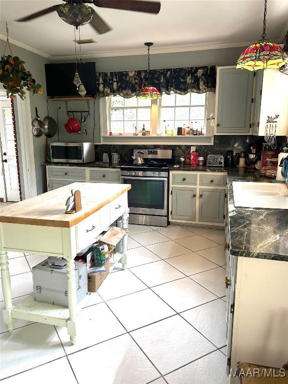 309 Broad St, Camden, AL 36726 - kitchen featuring stainless steel appliances, ornamental molding, healthy amount of natural light, tasteful backsplash, and a ceiling fan